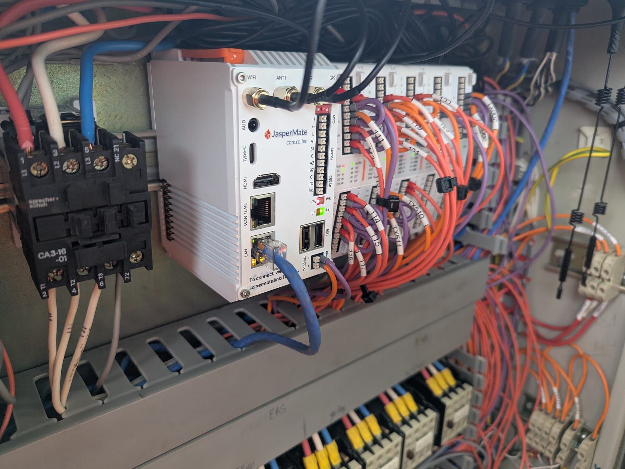 A JasperMate wired into the dredge's control panel beside contactors
